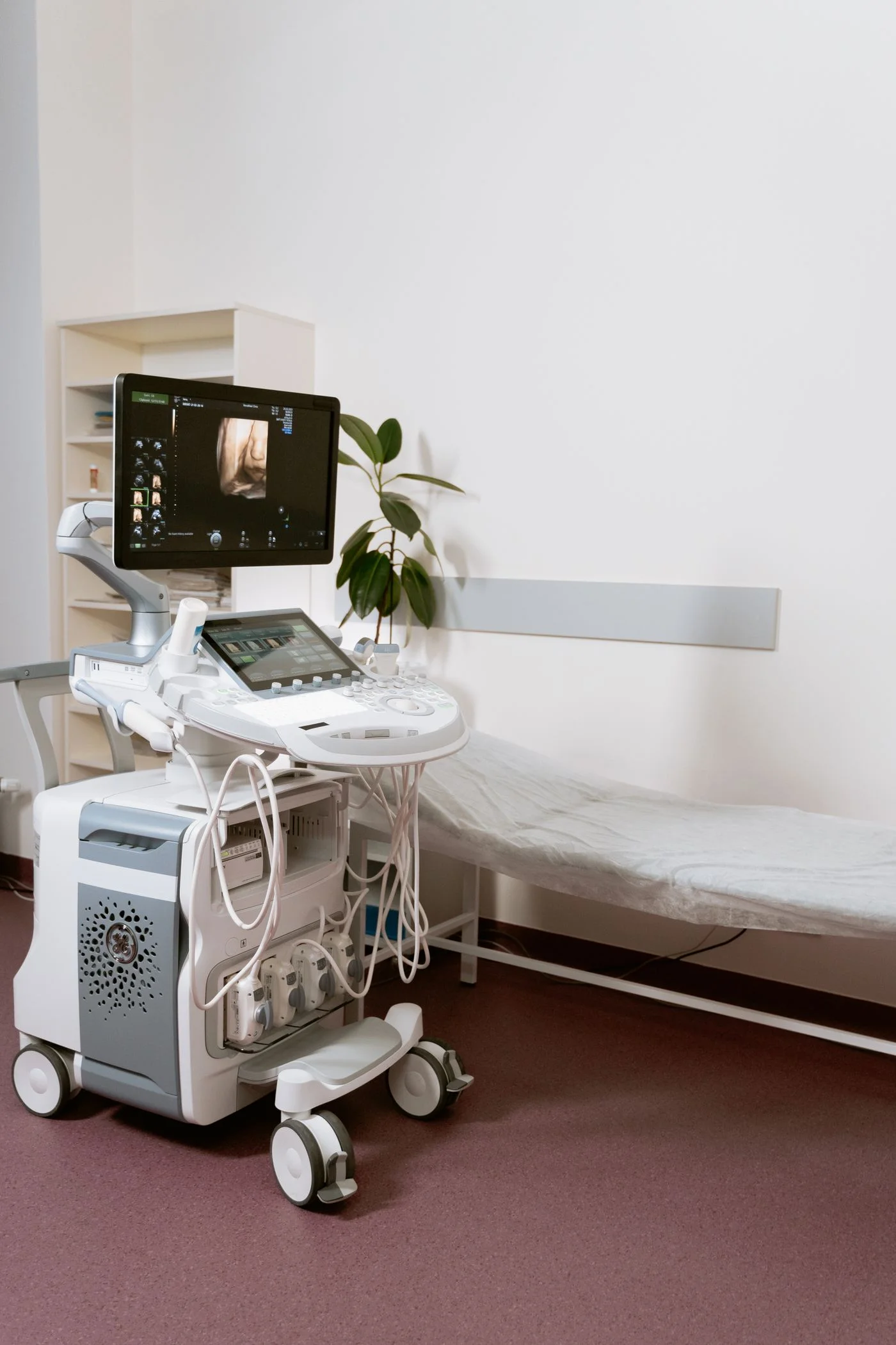 Ultrasound equipment beside a treatment couch in a clinical room