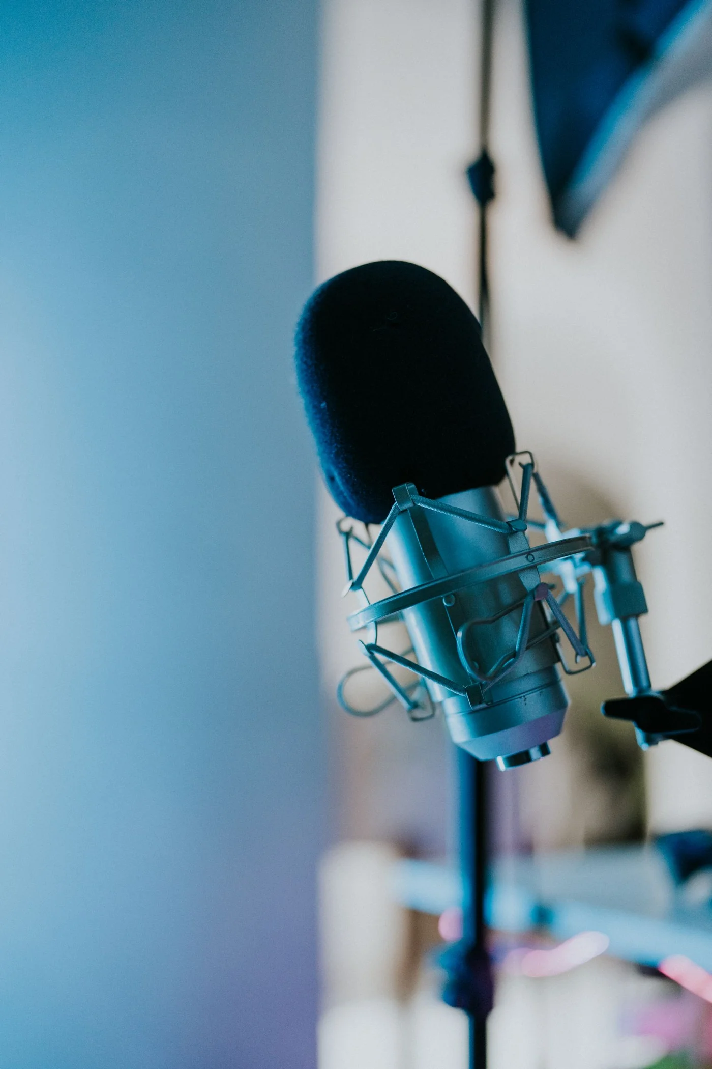 Studio microphone in a softly lit recording space