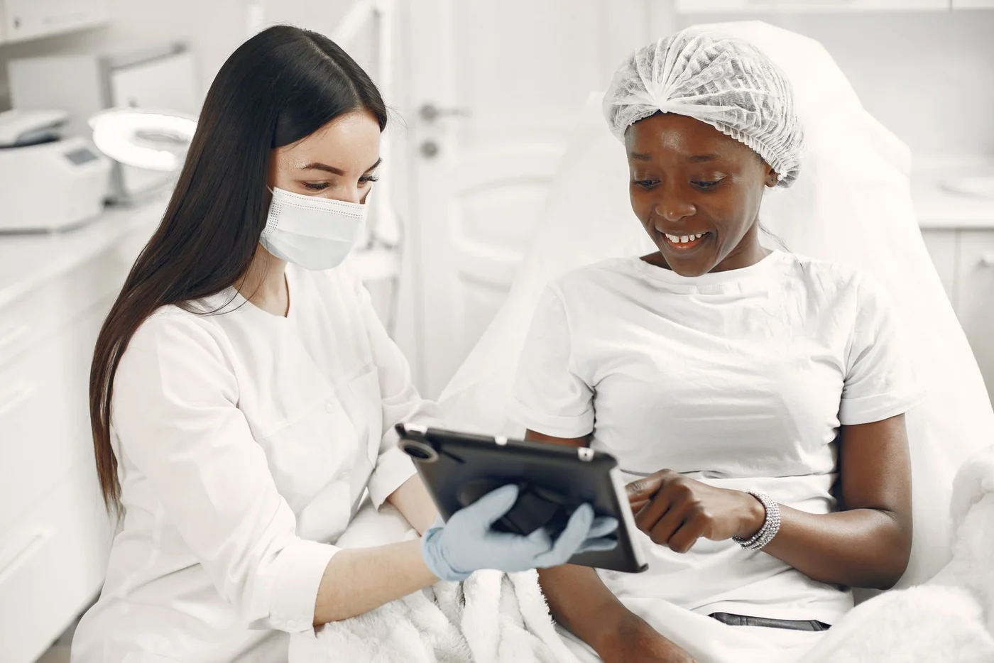 Specialist and adult client discussing information on a tablet