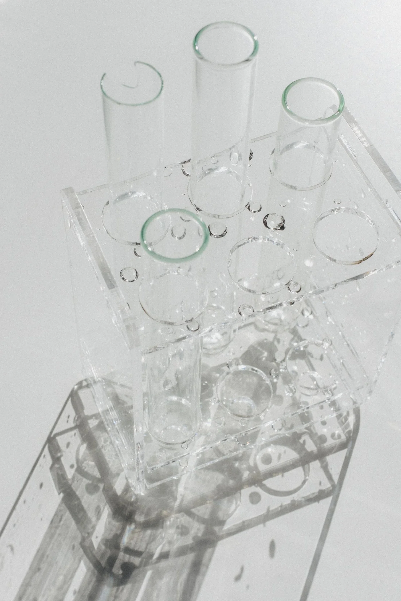 Clear glass laboratory test tubes on a white surface